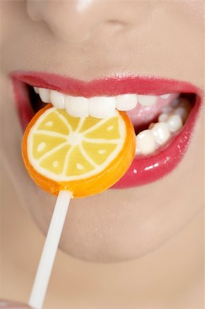 simsearch:400-04575822,k - Colorful Lollypop in perfect woman teeth and red lips mouth Photographie de stock - Aubaine LD & Abonnement, Code: 400-04205459