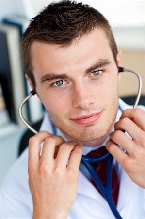 Portrait of an self-assured male doctor holding a stethoscope Stock Photo - Budget Royalty-Free & Subscription, Code: 400-04205508