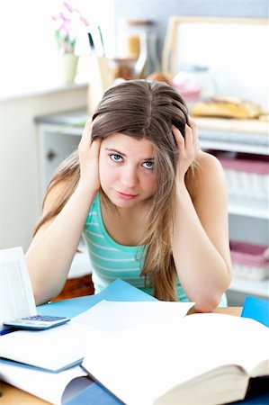 Serious woman studying in the kitchen Stock Photo - Budget Royalty-Free & Subscription, Code: 400-04205502