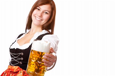 simsearch:400-07124078,k - Happy smiling woman in dirndl dress holding Oktoberfest beer stein. Isolated on white background. Stockbilder - Microstock & Abonnement, Bildnummer: 400-04206413