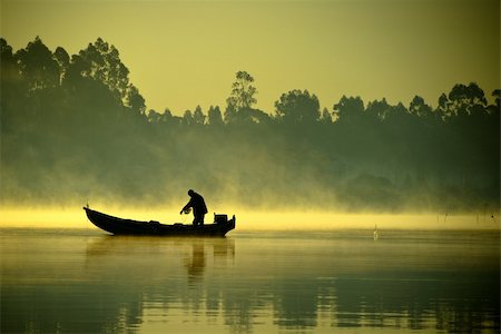 The boatman fishing on a lake. Stock Photo - Budget Royalty-Free & Subscription, Code: 400-04206509