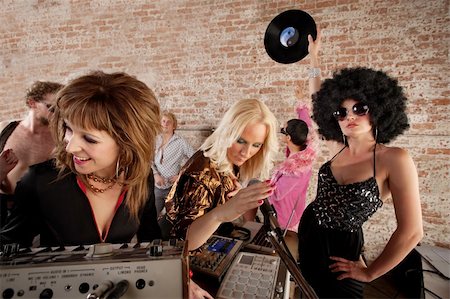 simsearch:400-04686050,k - Three female DJs performing at a 1970s Disco Music Party Photographie de stock - Aubaine LD & Abonnement, Code: 400-04207958