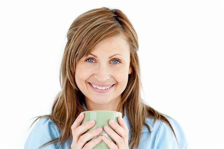 simsearch:400-04188263,k - Cute woman holding a cup of coffee smiling at the camera against white background Foto de stock - Super Valor sin royalties y Suscripción, Código: 400-04208070