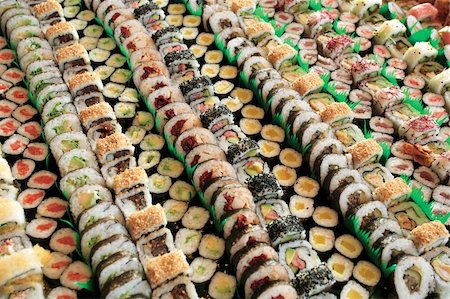 Photo of fresh maki sushi platter with a lot of variety. Selective focus on middle of the platter. Stock Photo - Budget Royalty-Free & Subscription, Code: 400-04208363