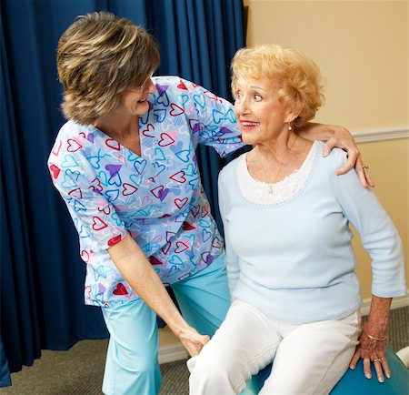 elderly therapy - Physical therapist helps a senior woman exercise using a pilates ball. Stock Photo - Budget Royalty-Free & Subscription, Code: 400-04208618