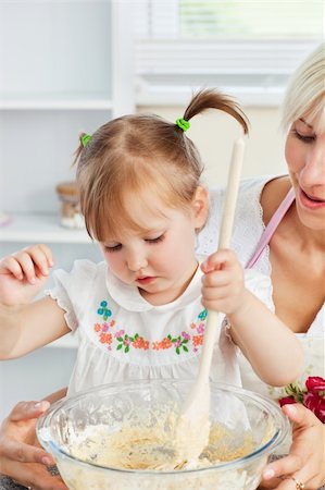 flour daughter - Sweet woman baking cookies with her daughter in kitchen Stock Photo - Budget Royalty-Free & Subscription, Code: 400-04208803