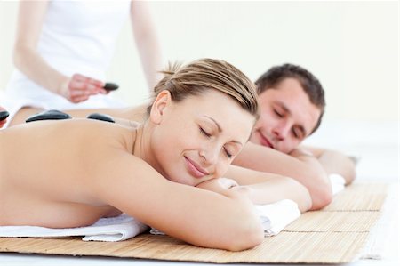 Positive young couple receiving a back massage with hot stones in a Spa center Stock Photo - Budget Royalty-Free & Subscription, Code: 400-04208837