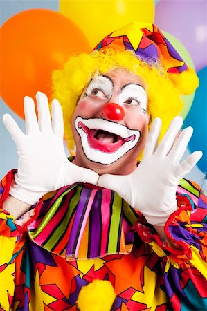 simsearch:400-04408991,k - Adorable birthday clown making a jazz hands gesture. Foto de stock - Super Valor sin royalties y Suscripción, Código: 400-04208944