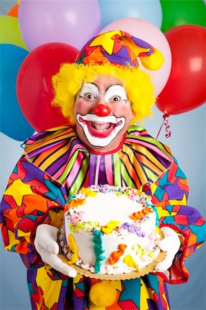 Crazy clown with balloons, holding a birthday cake. Stock Photo - Budget Royalty-Free & Subscription, Code: 400-04208952