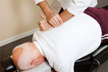 Closeup of chiropractors hands doing spinal adjustment on senior man. Stockbilder - Microstock & Abonnement, Bildnummer: 400-04208970