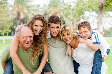 piggyback brothers - Granparents giving piggy-ride to young generation as they smile at camera Stock Photo - Budget Royalty-Free & Subscription, Code: 400-04209151