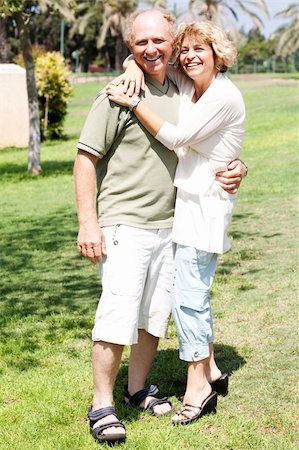 simsearch:400-04522125,k - Affectionate senior couple embracing in the park and posing in front of camera Stock Photo - Budget Royalty-Free & Subscription, Code: 400-04209160