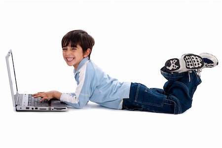 simsearch:400-05745952,k - Young boy lying on floor and surfing on his laptop Stock Photo - Budget Royalty-Free & Subscription, Code: 400-04209289