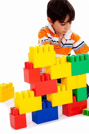 plastic toy family - Young boy playing with building blocks on white background Stock Photo - Budget Royalty-Free & Subscription, Code: 400-04209303