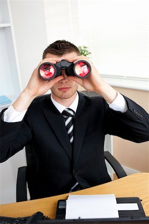 simsearch:400-05900688,k - Caucasian young businessman looking through binoculars sitting in his office Foto de stock - Super Valor sin royalties y Suscripción, Código: 400-04209316