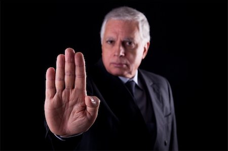 simsearch:400-04213571,k - old businessman  with his hand raised in signal to stop, isolated on black background, Studio shot Foto de stock - Royalty-Free Super Valor e Assinatura, Número: 400-04209484