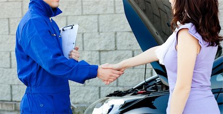 Caucasian young mechanic shaking hands with a female customer in front of a car Stock Photo - Budget Royalty-Free & Subscription, Code: 400-04209858