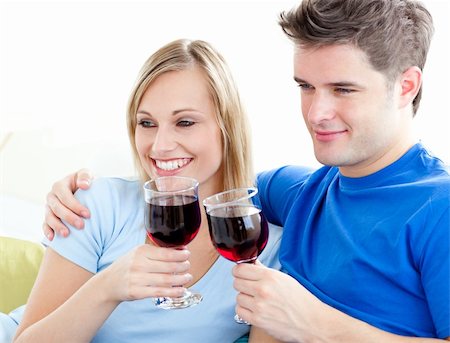 simsearch:400-04212835,k - Affectionate couple drinking wine sitting on a sofa in the living room Photographie de stock - Aubaine LD & Abonnement, Code: 400-04209944