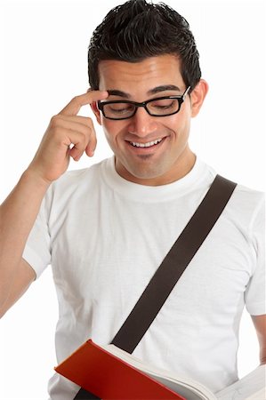 Smiling university or college student or young man reading a book.  White background. Photographie de stock - Aubaine LD & Abonnement, Code: 400-04200146