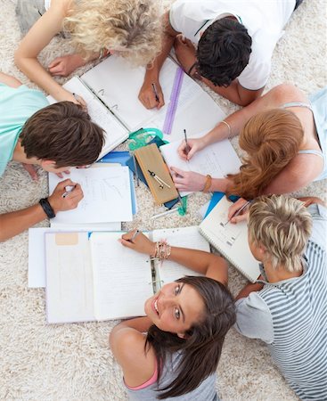 High angle of teenagers lying on the ground studying together Stock Photo - Budget Royalty-Free & Subscription, Code: 400-04200295