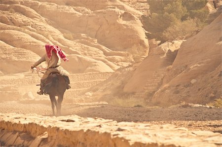 arabian man riding his horse on rocky desert Stock Photo - Budget Royalty-Free & Subscription, Code: 400-04200329