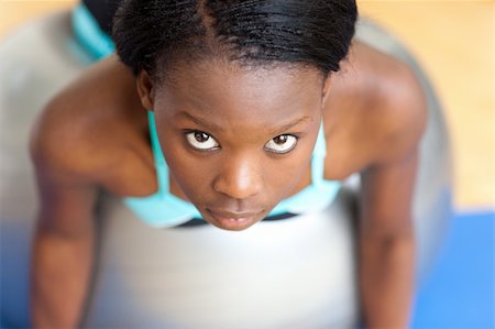 pilates african american - Beautiful woman working out with a pilates ball at home Stock Photo - Budget Royalty-Free & Subscription, Code: 400-04200638