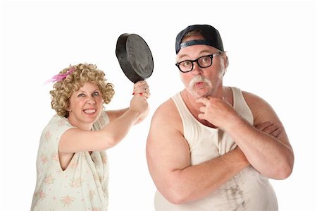 photo of a husband abusing wife - Wife readies a pan to her clueless husband's head Stock Photo - Budget Royalty-Free & Subscription, Code: 400-04201095