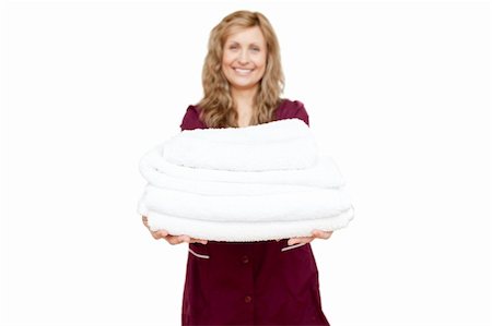 Smiling woman holding white towels against white background Stock Photo - Budget Royalty-Free & Subscription, Code: 400-04201118