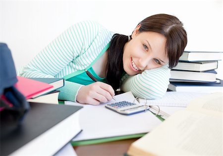 simsearch:400-04484714,k - Smiling student doing her homework on a desk at home Stock Photo - Budget Royalty-Free & Subscription, Code: 400-04201162