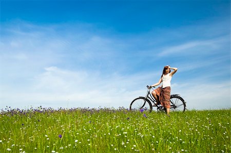 simsearch:400-04201795,k - Happy young woman with a vintage bicycle on a green meadow Stock Photo - Budget Royalty-Free & Subscription, Code: 400-04201792