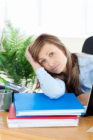 simsearch:400-05729276,k - Upset young businesswoman sitting at her desk in the office Stock Photo - Budget Royalty-Free & Subscription, Code: 400-04201869