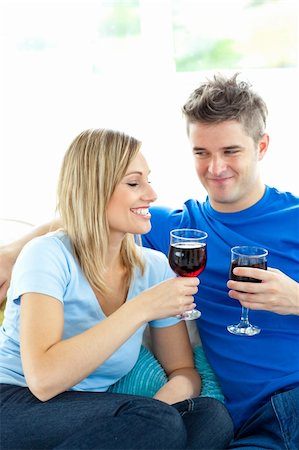 divert - Adorable couple drinking wine together in the living-room at home Stock Photo - Budget Royalty-Free & Subscription, Code: 400-04202082