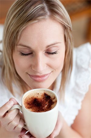 simsearch:400-04335902,k - Delighted woman drinking a coffee at home Photographie de stock - Aubaine LD & Abonnement, Code: 400-04202141