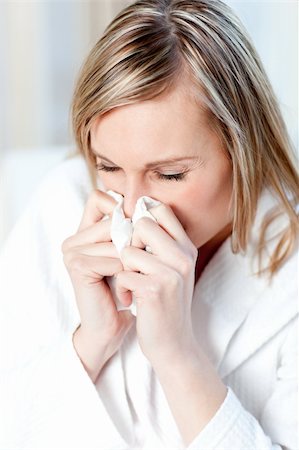 Sick woman blowing sitting on a sofa Stock Photo - Budget Royalty-Free & Subscription, Code: 400-04202190