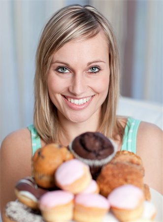 simsearch:400-04729451,k - Bright woman holding a plate of cakes at home Stock Photo - Budget Royalty-Free & Subscription, Code: 400-04202204
