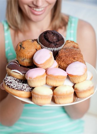 Blond woman holding a plate of cakes at home Stock Photo - Budget Royalty-Free & Subscription, Code: 400-04202203