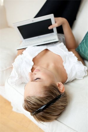 simsearch:400-04709946,k - Beautiful young woman surfing the internet lying on a sofa at home Stockbilder - Microstock & Abonnement, Bildnummer: 400-04202251