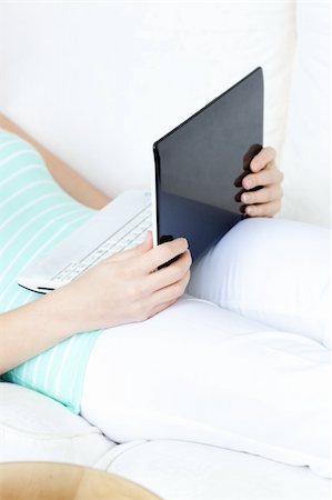 simsearch:400-04709946,k - Close-up of a woman using a laptop lying on a sofa at home Stockbilder - Microstock & Abonnement, Bildnummer: 400-04202271