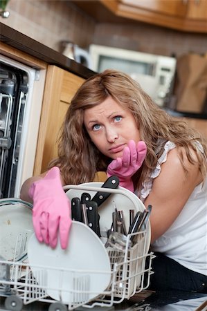 Smiling young woman cleaning in a kitchen at home Stock Photo - Budget Royalty-Free & Subscription, Code: 400-04202341