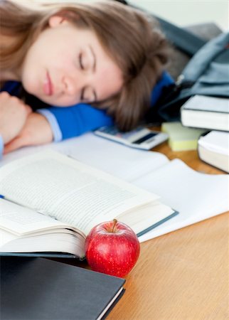 simsearch:400-05668910,k - Young woman sleeping on a desk after doing homework Stock Photo - Budget Royalty-Free & Subscription, Code: 400-04202925