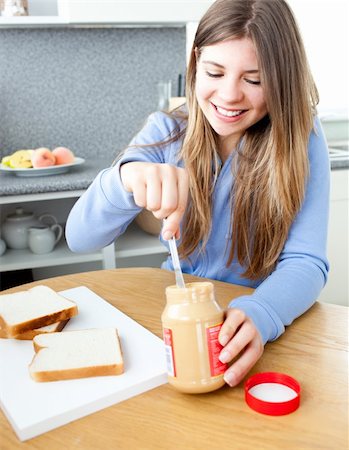 peanut butter woman - Glowing woman woman eating peanut butter in a kitchen Stock Photo - Budget Royalty-Free & Subscription, Code: 400-04202923