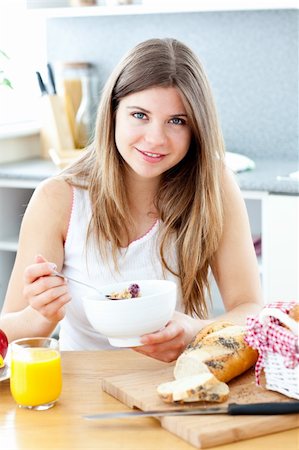 simsearch:400-04708507,k - Beautiful woman eating breakfast in her kitchen Stock Photo - Budget Royalty-Free & Subscription, Code: 400-04202933
