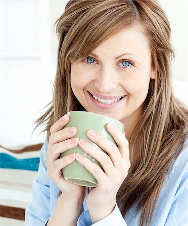 simsearch:400-04188263,k - Positive attractive businesswoman holding a cup smiling at the camera Foto de stock - Super Valor sin royalties y Suscripción, Código: 400-04202969