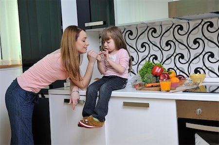 happy young family have lunch time with fresh fruits and vegetable food in bright kitchen Stock Photo - Budget Royalty-Free & Subscription, Code: 400-04203925