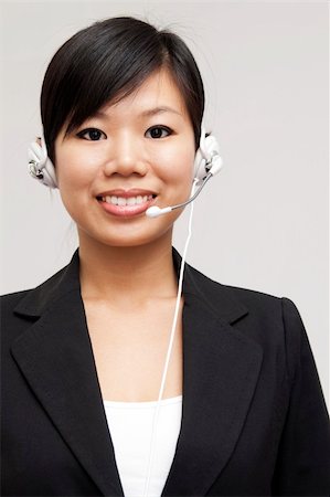 simsearch:400-03943051,k - Friendly Customer Representative with headset smiling during a telephone conversation Stock Photo - Budget Royalty-Free & Subscription, Code: 400-04214604