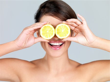 Portrait of beautiful woman, she holding fresh lemon Stock Photo - Budget Royalty-Free & Subscription, Code: 400-04214820