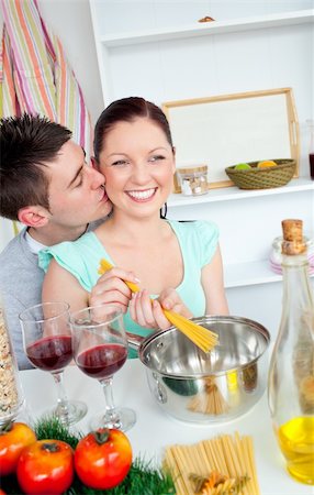 Delighted young couple cooking spaghetti in the kitchen at home Stock Photo - Budget Royalty-Free & Subscription, Code: 400-04214942