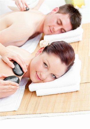 Relaxed young couple receiving a back massage with hot stones in a spa center Stock Photo - Budget Royalty-Free & Subscription, Code: 400-04214953