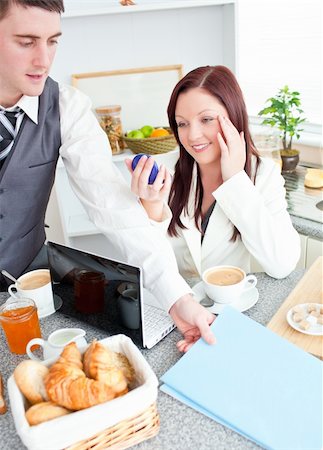simsearch:400-05741872,k - Couple of businesspeople having breakfast in the kitchen at home Stock Photo - Budget Royalty-Free & Subscription, Code: 400-04214964