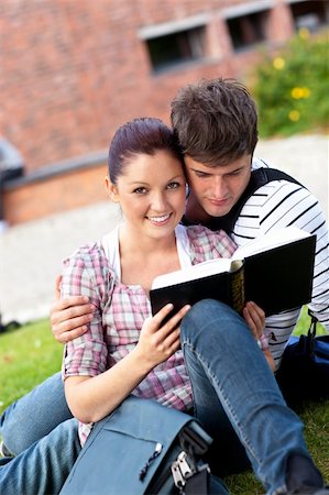 Serious couple of students reading a book sitting on grass at their campus university Photographie de stock - Aubaine LD & Abonnement, Code: 400-04215048